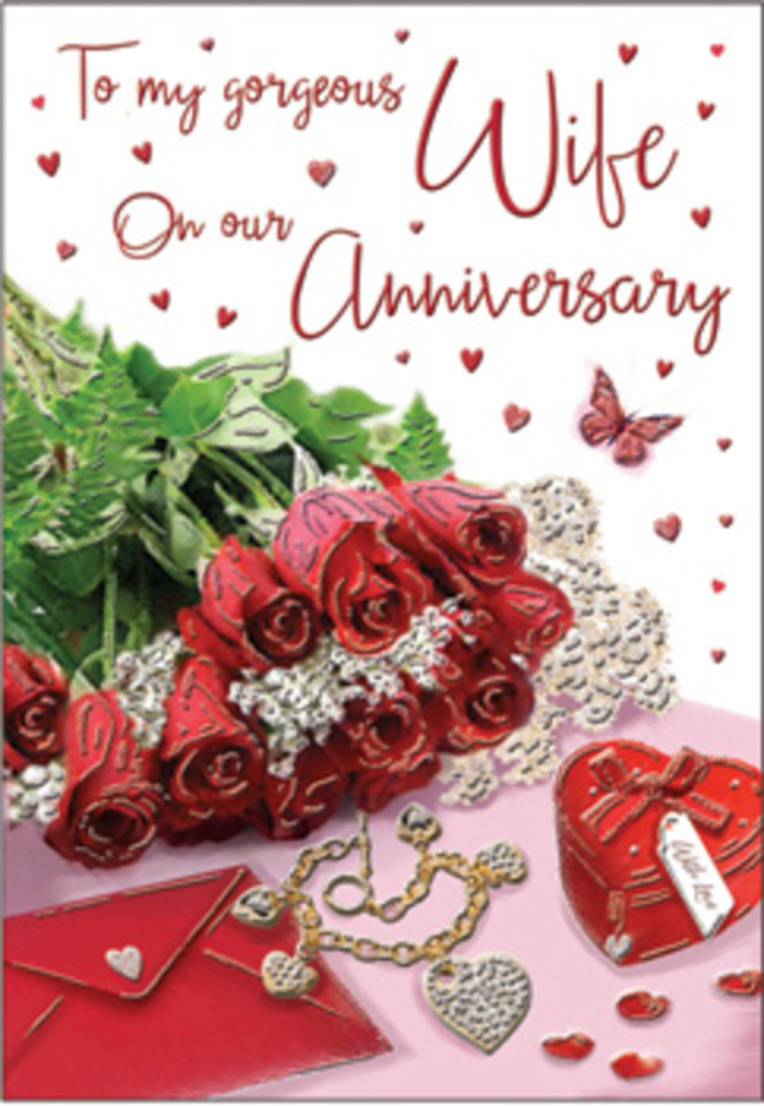 This richly detailed anniversary scene unfolds like a memory carefully arranged on a tabletop in Stratford, perhaps after a stroll along the canal or an evening near the Theatre Royal. At the centre stands a classic bouquet of red roses, each flower luxuriously full and impeccably shaped, their petals stacked in intricate layers that form lush, deep crimson rosettes. The roses are intertwined with abundant greenery, the leaves varied in shape but uniformly fresh and vibrant, creating a natural frame that heightens the drama of the red blooms without overshadowing them. The bouquet appears elegantly wrapped or gathered, its stems and foliage drawn together with the sort of skill one expects from a seasoned florist familiar with anniversaries and milestone celebrations. Nearby rests a coordinating jewellery set, its polished surfaces catching and reflecting the soft ambient light. A vivid red box, square or slightly rounded, sits close to the flowers, its colour mirroring the intensity of the petals and suggesting a precious gift nestled within. Around these focal pieces, subtle heart motifs, delicate lace-like textures, and fine decorative accents create layers of visual interest that invite the eye to explore slowly. A gently scripted anniversary message flows across the card, its sweeping lines echoing the natural curves of the rose petals and the loops of jewellery. Soft textures of imagined velvet, gold, silk ribbon, and smooth card stock combine to evoke warmth and intimacy, as if the card were resting on a dining table awaiting a candlelit celebration at home. The overall impression is one of long-nurtured love-a relationship cultivated with patience and care, very much like a garden tended through many Stratford seasons.