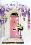 This Stratford doorway scene feels like the visual embodiment of a warm, handwritten 'welcome home' note. The front door, painted in a soft, rosy pink, sits within a clean whitewashed facade, the colour just bold enough to stand out yet gentle enough to soothe. Above and to the sides, wisteria dangles in long, plentiful sprays of lavender blossoms, each cluster composed of many tiny petals that form a loose, trailing canopy over the entrance. The flowers create subtle shadows on the wall as the light moves, giving the whole scene a layered, textured softness. At the very threshold, a practical grey metal bucket has taken on a new life as an elegant container for a lush bouquet. It is filled to the brim with white and cream roses, their petals unfurling in generous swirls, touched here and there with hints of soft green at the base. Delicate foliage peeks through the blooms, lending a fresh, leafy counterpoint to the creamy tones. Tied around the bucket is a pink ribbon, its colour closely matching the door, with lightly trailing ends that rest against the metal and stone. The lighting suggests a gentle daytime calm, perhaps late afternoon in a quiet Stratford side street tucked between Westfield and the Olympic Park, where townhouses and flats sit shoulder to shoulder. The arrangement looks like a carefully chosen new home gift, maybe delivered the same day the keys were collected, symbolising support, joy, and the hope that each time the door opens, the residents are greeted with beauty and comfort. It is a simple, charming composition that wraps up the emotion of moving into a new place in one fragrant, pastel embrace.